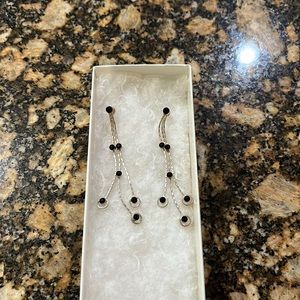 Long silver earrings silver color. Beautiful on. Must have earrings.